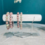 Natural Clear Quartz crystal bracelet holder with multi-colored beaded bracelets on display