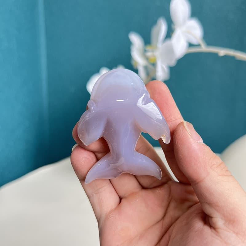 Beautiful banding patterns in dolphin shaped agate crystal carving