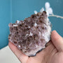 Side view of natural amethyst crystal cluster with deep purple points