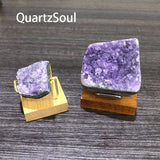 Natural amethyst specimens on wooden display stands with metal holders for crystal collectors