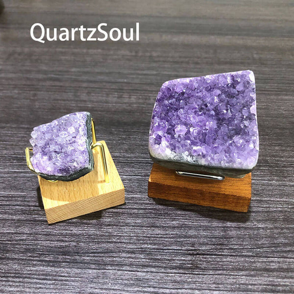 Natural amethyst specimens on wooden display stands with metal holders for crystal collectors