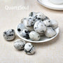 Natural Black Rainbow Moonstone Tumbled Gemstones on Round White Plate