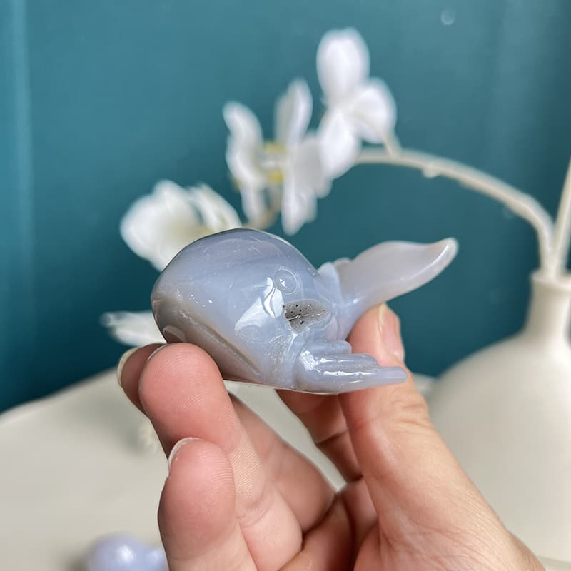 Side view of blue agate whale crystal carving showing natural patterns