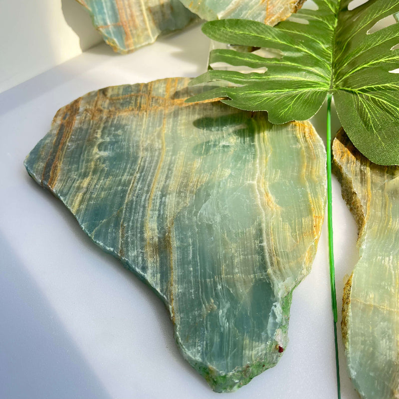 Wholesale blue onyx slab paired with complementary healing crystals