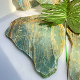 Wholesale blue onyx slab paired with complementary healing crystals