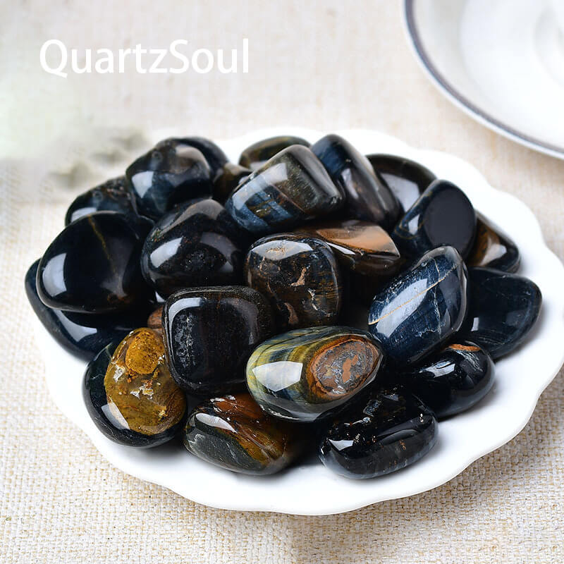 Premium Blue Tiger's Eye tumbled gemstones collection arranged on white plate