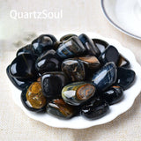 Premium Blue Tiger's Eye tumbled gemstones collection arranged on white plate