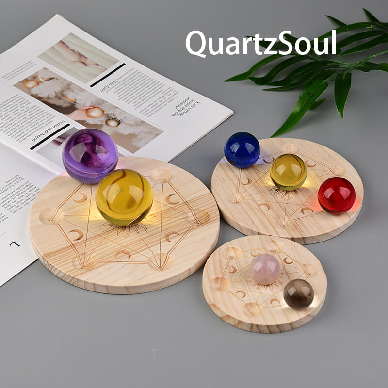 Wooden crystal ball stand with sacred geometry sun and moon phases design