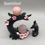 Handcrafted cherry blossom crystal ball stand featuring dual sphere holders and floral accents