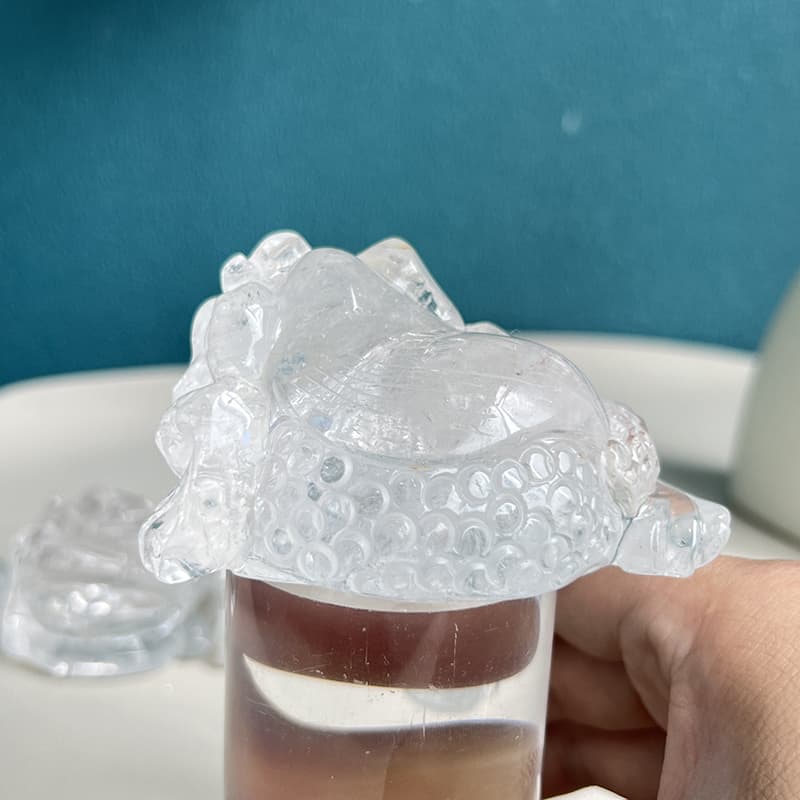 Intricate detail work on clear quartz animal carving