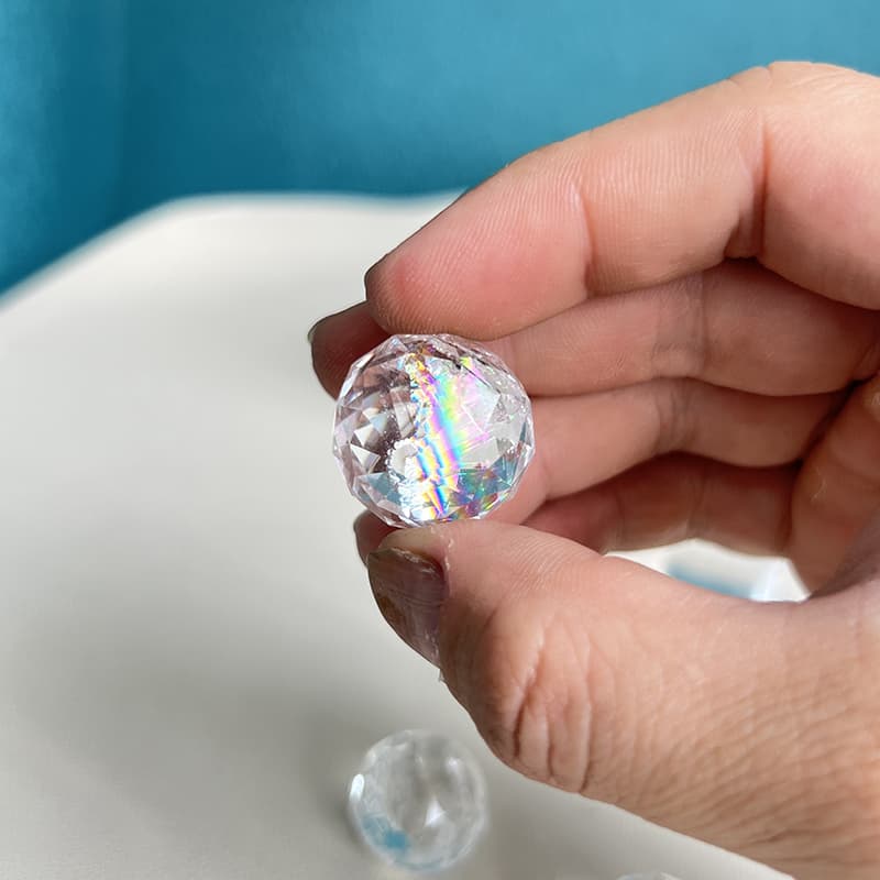Close-up of expertly faceted Clear Quartz mini sphere showing brilliant light reflection