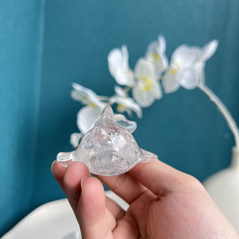Light reflecting through Clear Quartz Flying Fish Carving