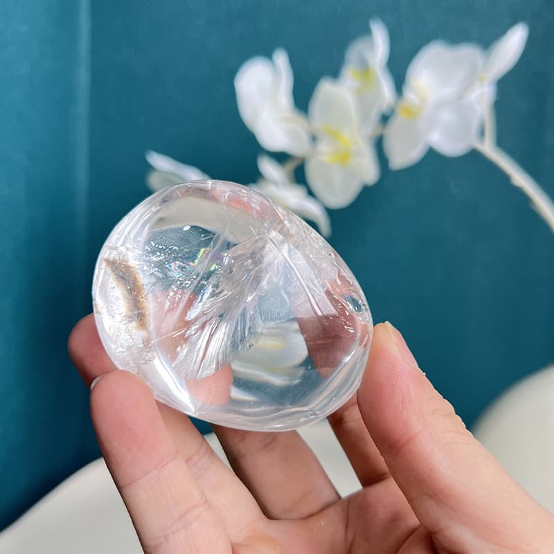 Clear quartz free form displaying metaphysical properties with rainbow light refraction