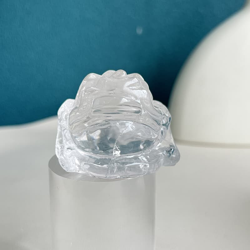 Detailed texture of hand-carved quartz golden toad sculpture