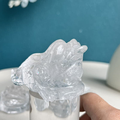 Clear quartz golden toad crystal carving symbolizing prosperity and abundance