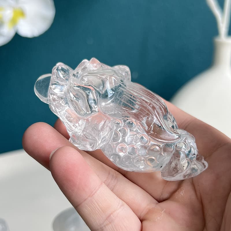 Side view of clear quartz golden toad crystal carving showing detailed craftsmanship