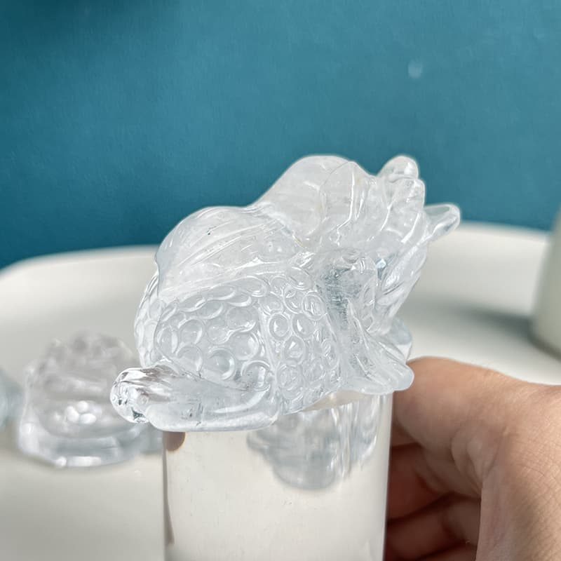 Side view of handcrafted clear quartz golden toad carving