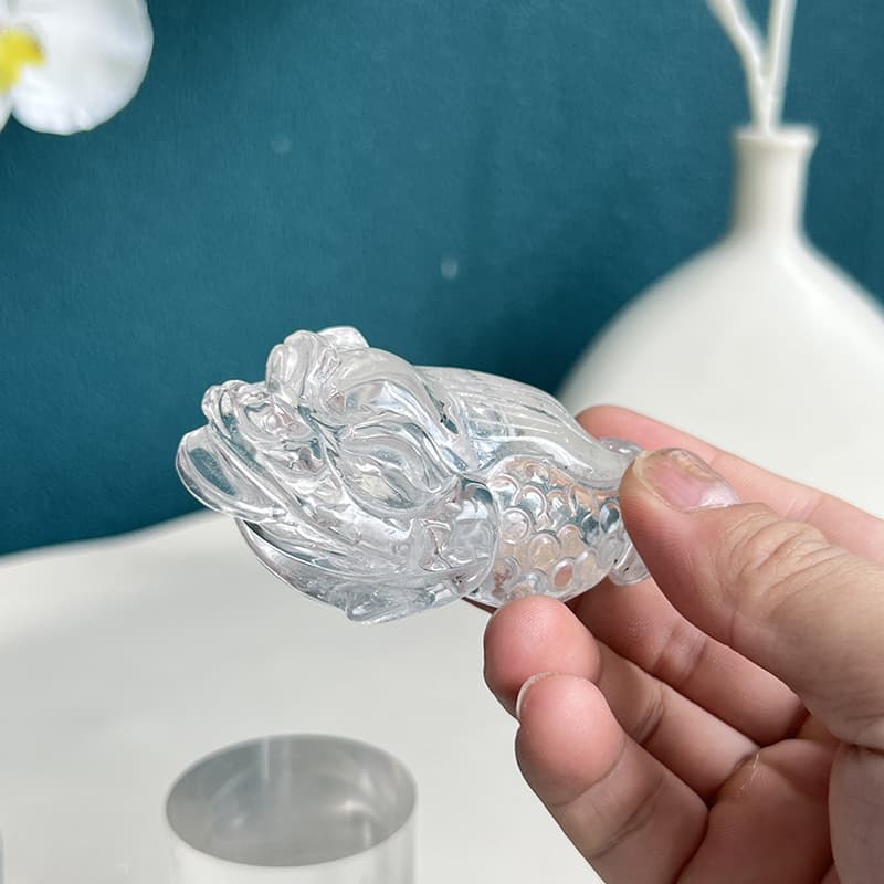 Natural light showcasing clarity and brilliance of quartz golden toad crystal carving