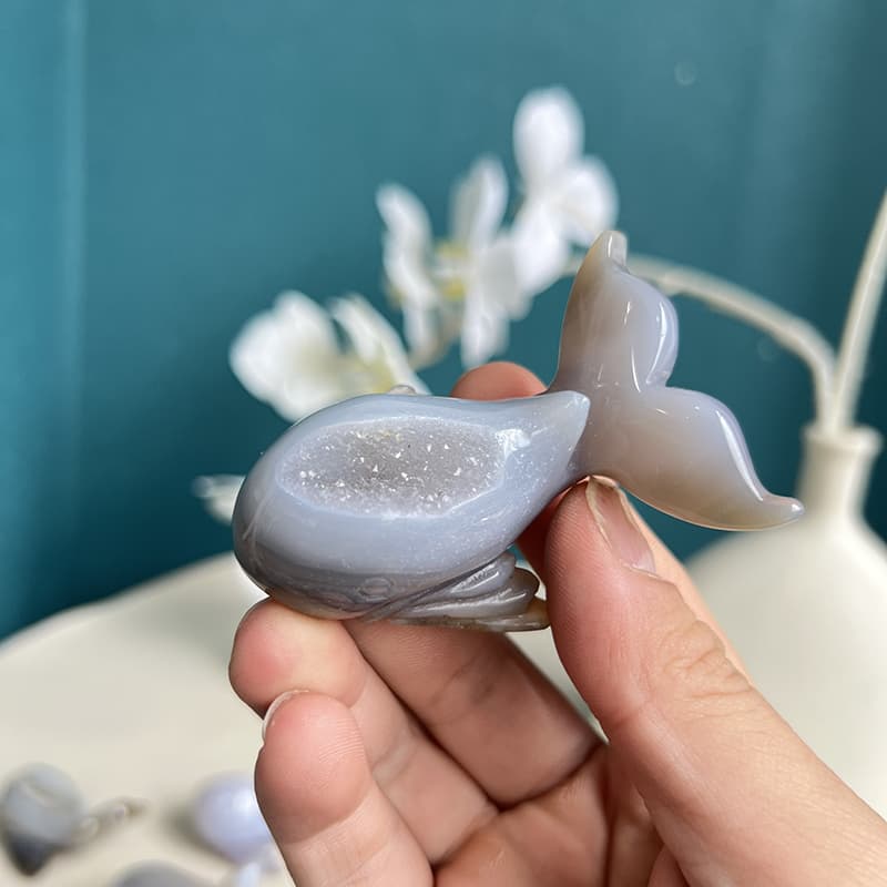 Dolphin agate crystal carving displayed in natural light showing unique luster of agate crystal