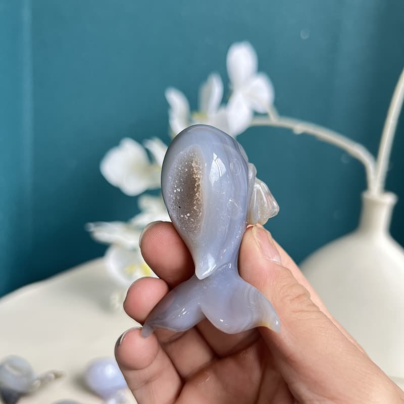 Side view of dolphin agate crystal carving showing perfect curves and natural patterns