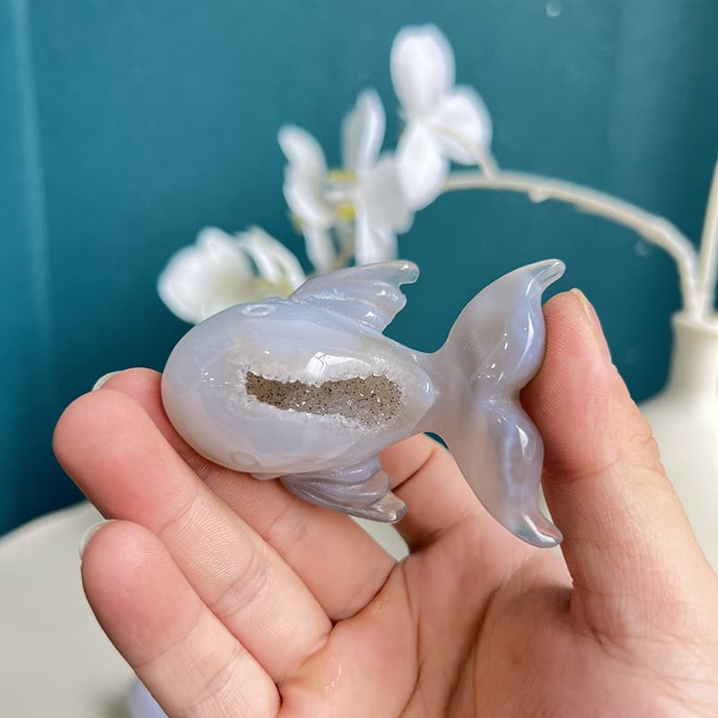 Dolphin agate crystal carving with light passing through translucent areas
