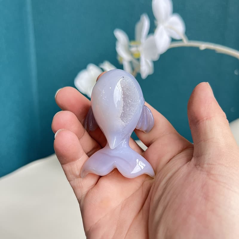Polished surface of dolphin agate crystal carving showing natural luster