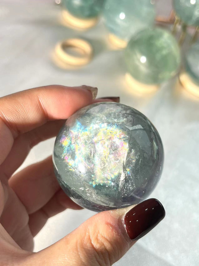 Various sizes of light green fluorite crystal spheres