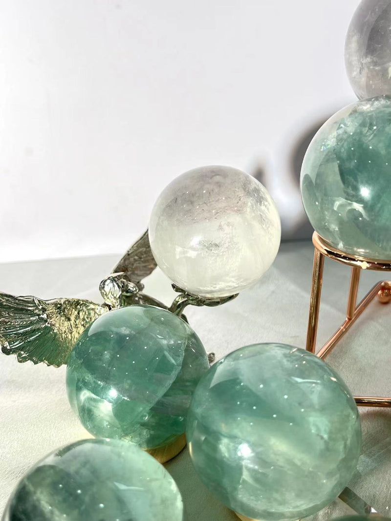 Natural banding patterns in light green fluorite crystal sphere