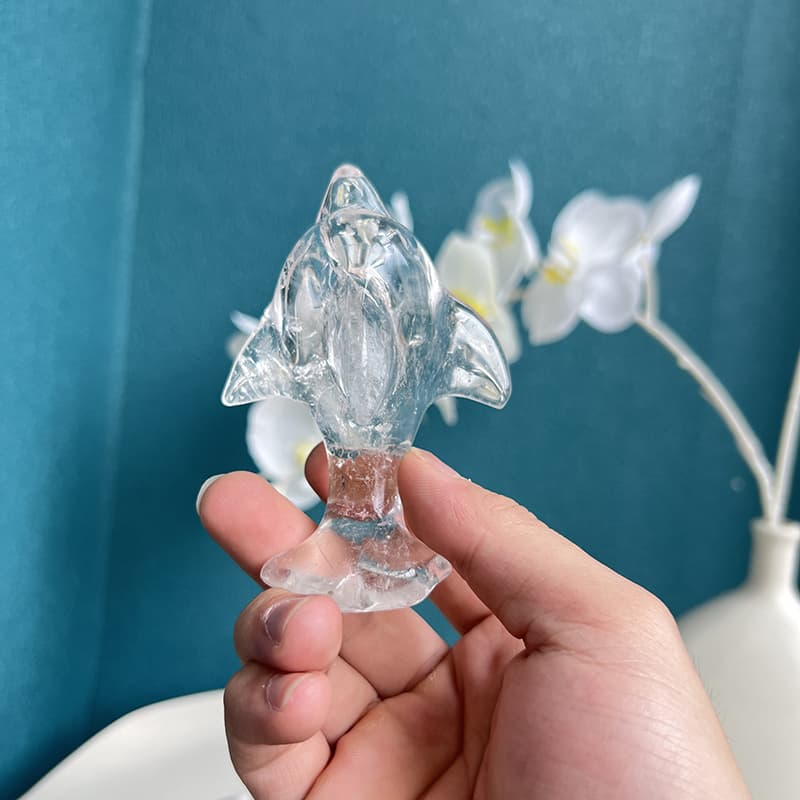 Clear quartz flying fish carving catching natural light showing crystal clarity