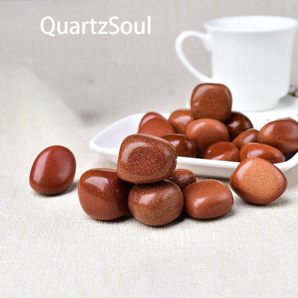 Premium Gold Sandstone tumbled stones with copper sparkles in white ceramic plate