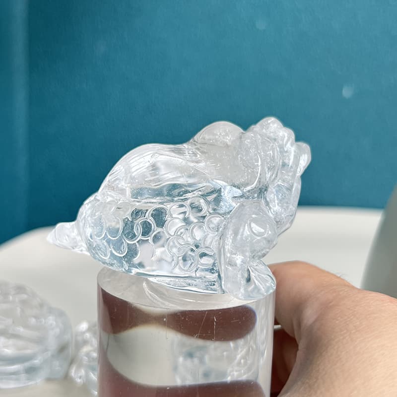 Detailed craftsmanship of golden toad crystal carving