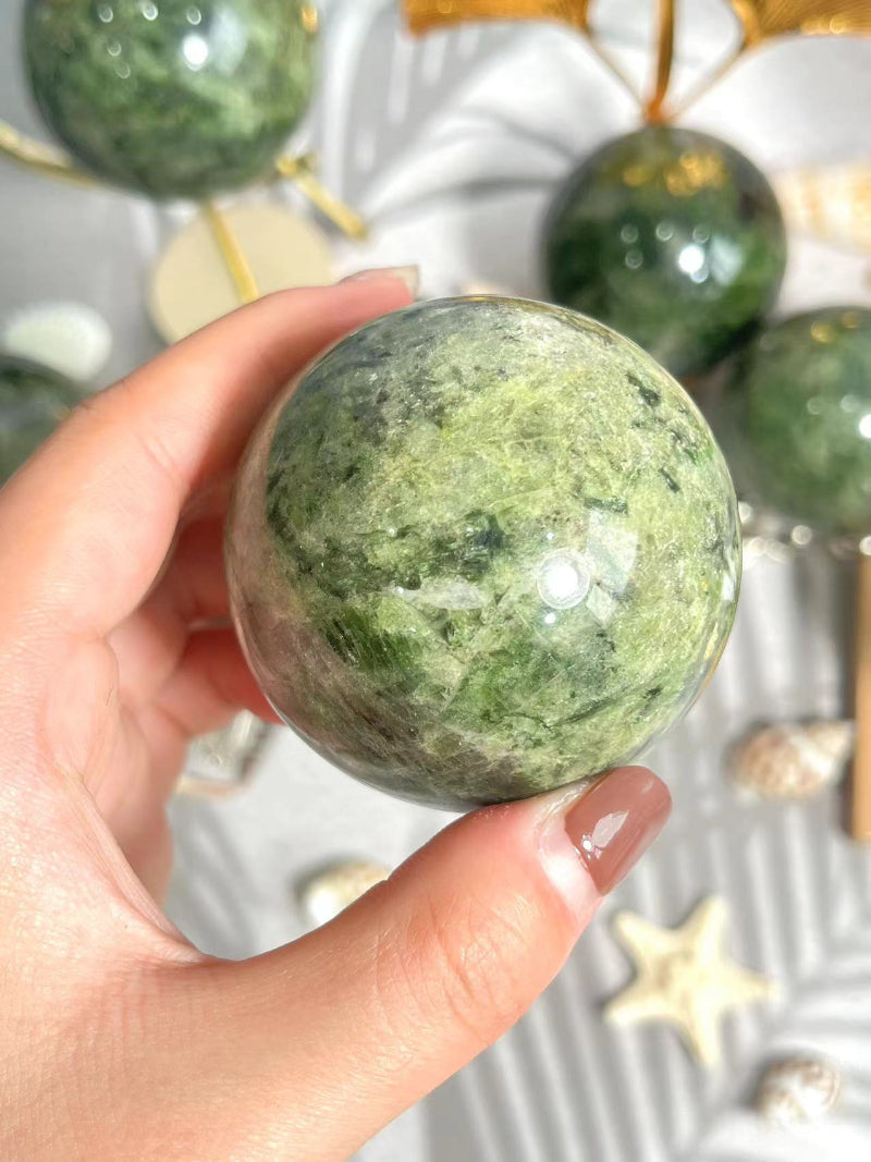Green Apidote Crystal Sphere on elegant display stand for home decor