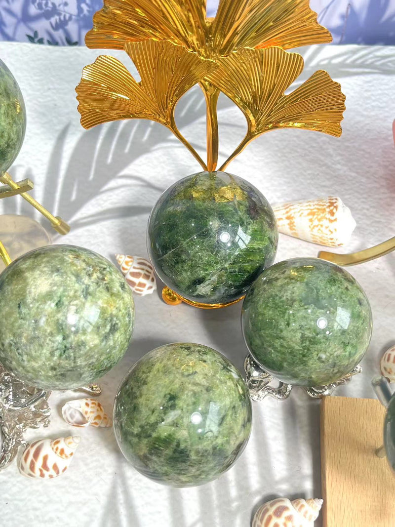 Green Apidote Crystal Sphere held in hand showing scale and vibrant color