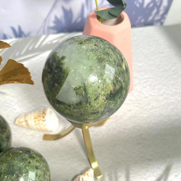 Polished Green Apidote Crystal Sphere showing natural inclusions and clarity