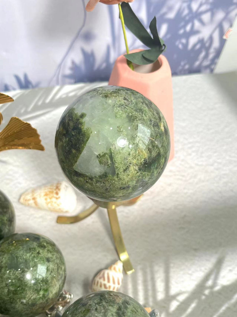 Polished Green Apidote Crystal Sphere showing natural inclusions and clarity