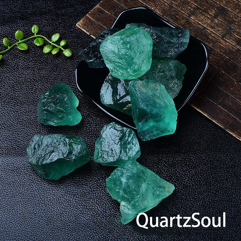 Raw Green Fluorite crystal specimens arranged in black display dish