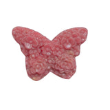 Rhodonite butterfly crystal carving displayed on wooden stand for home decor