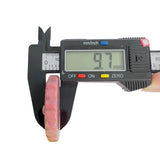 Digital caliper showing thickness of Rhodonite crystal carving at 9.7mm