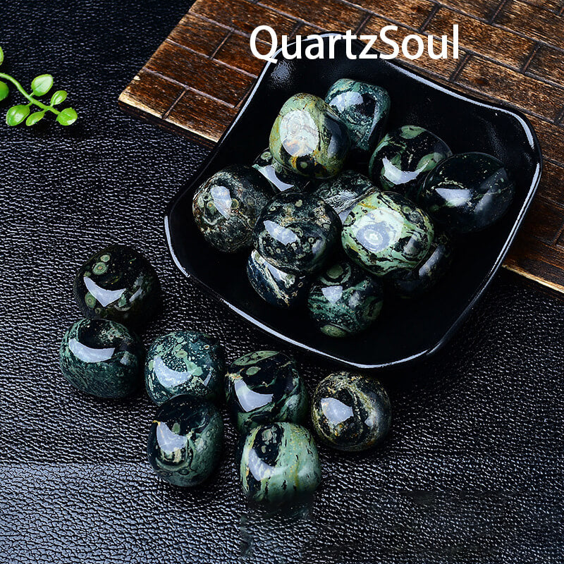 Bulk collection of Malachite tumbled stones showing variety of green patterns and sizes