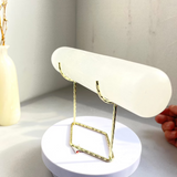 Metal stand showcasing precious mineral specimens