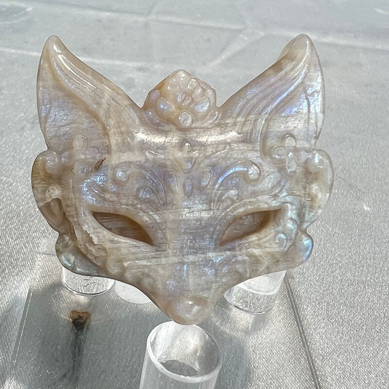 Close-up detail of moonstone fox carving facial features