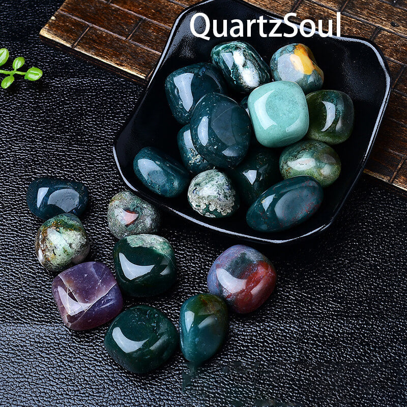 Moss Agate tumbled stones displayed in black dish showcasing earth element healing crystals
