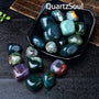 Moss Agate tumbled stones displayed in black dish showcasing earth element healing crystals