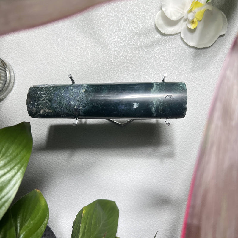 Close-up of moss agate crystal patterns in premium jewelry display stand