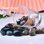 Natural Ocean Jasper tumbled stones displayed in glass bowl with various orbital patterns