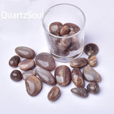 Natural peach sunstone tumbled stones collection with various sizes and shimmering effect