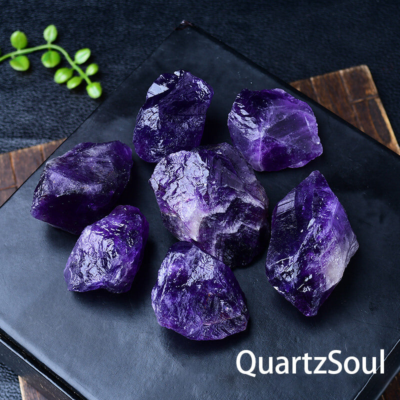 Premium raw amethyst crystal chunks with vibrant purple coloration on display plate