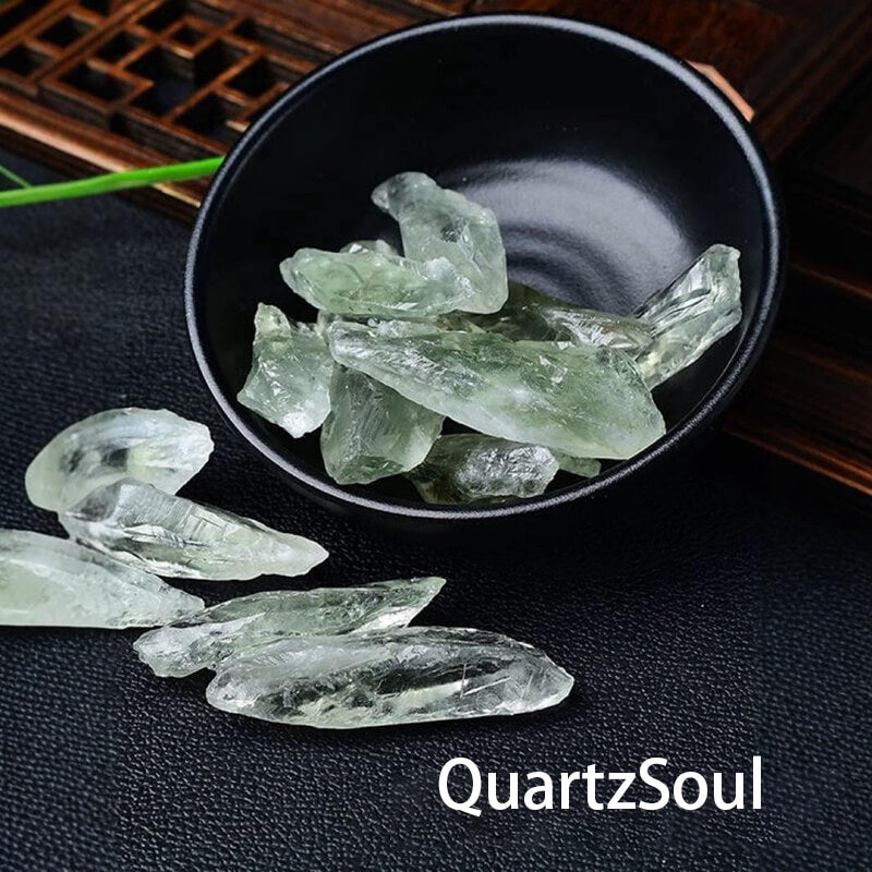 Natural raw green quartz crystal fragments in decorative black bowl
