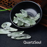 Natural raw green quartz crystal fragments in decorative black bowl