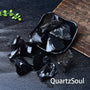 Natural raw obsidian crystal volcanic glass with glossy black surface